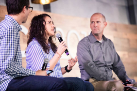 3 people at a speaking event.